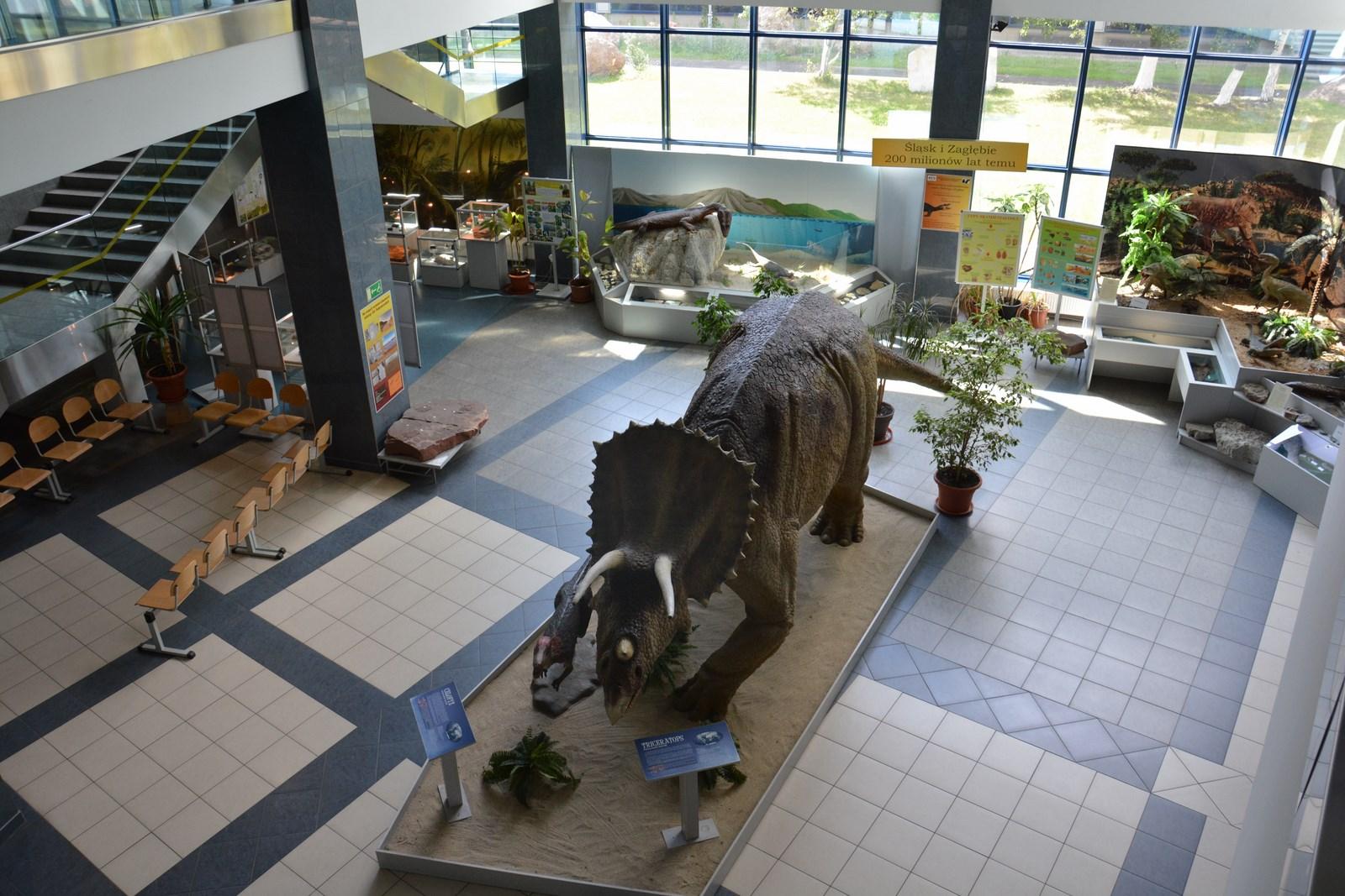 Wnętrze budynku uczelni na środku stoi dinozaur